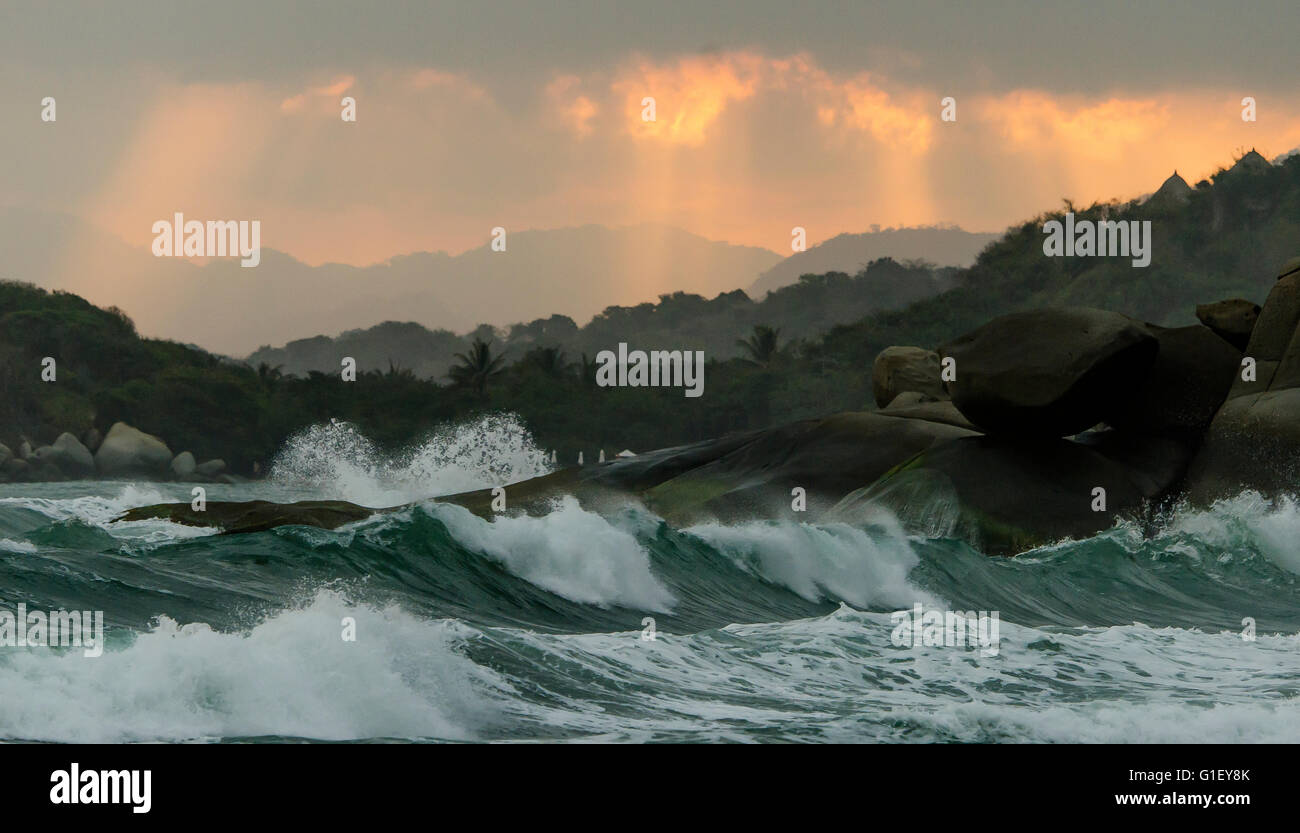 Big waves rocks and moody sky at Tayrona National Park Santa Marta Colombia Stock Photo