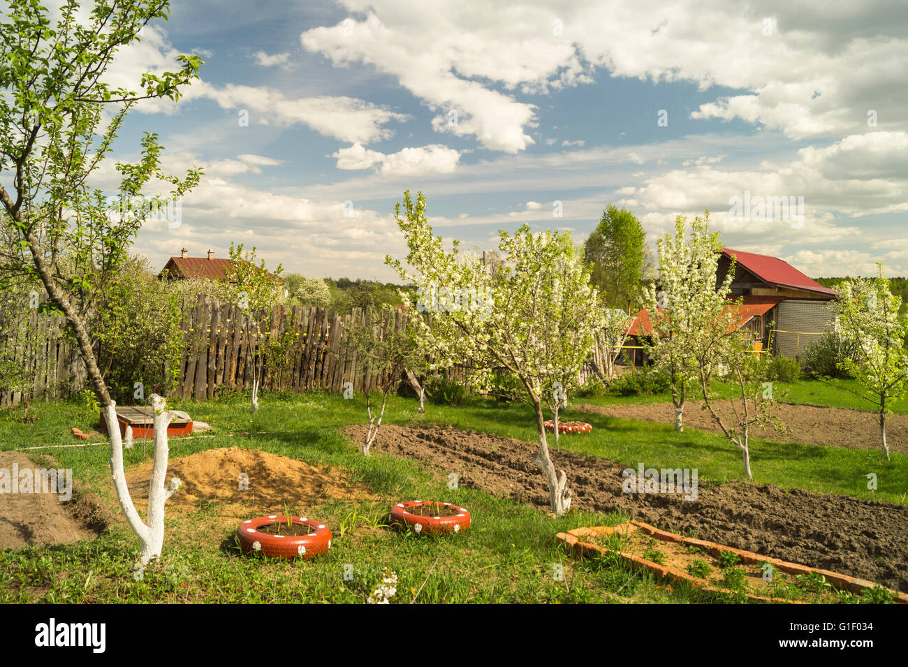 Spring landscape with beautiful sky and flowering garden in rural terrain Stock Photo