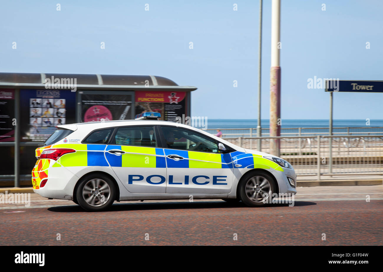 Police car part of Lancashire Constabulary fleet, in motion being driven along the seafront at Blackpool, Lancashire, UK. Stock Photo