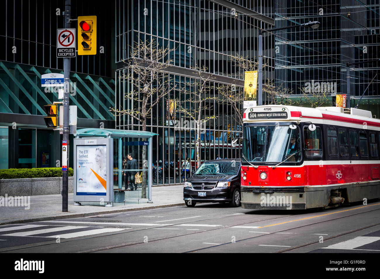 Streetcar and modern buildings at the intersection of Simcoe Street and