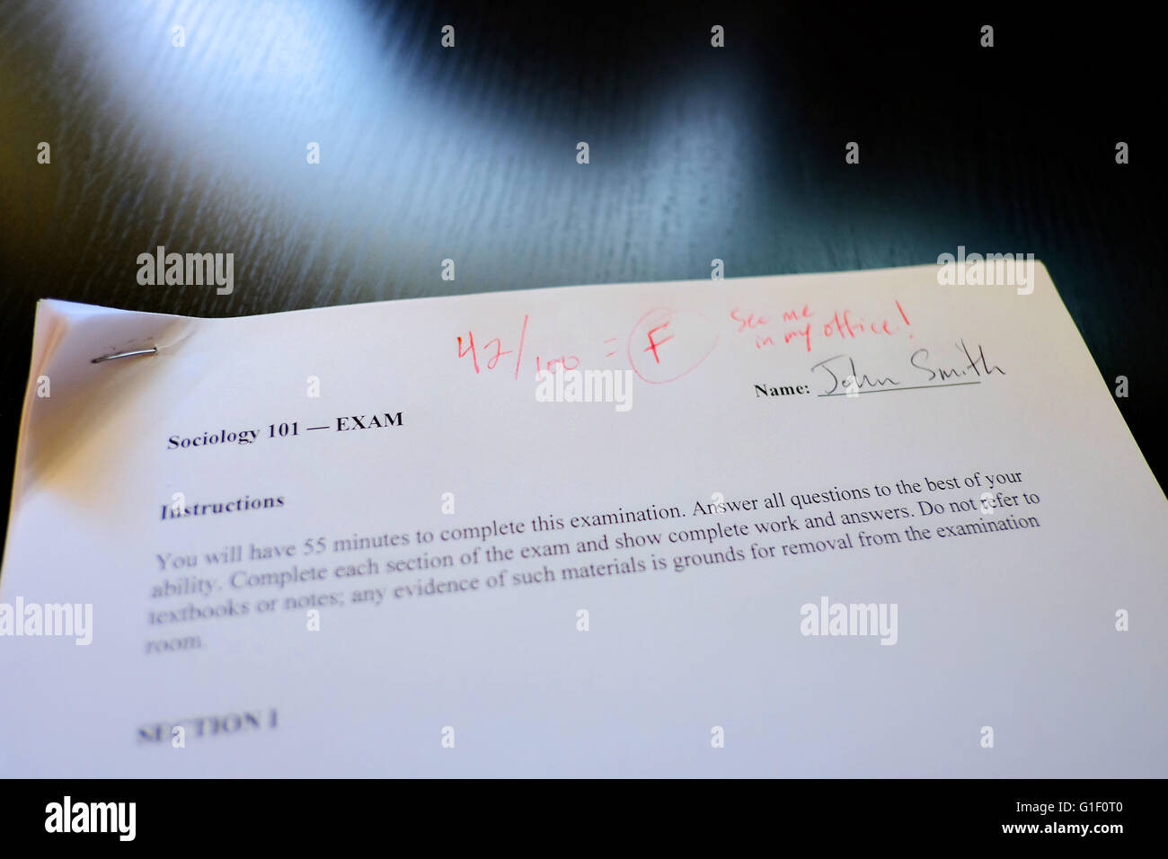 Final exam paper showing low score and 'F' (failure) grade. Stock Photo