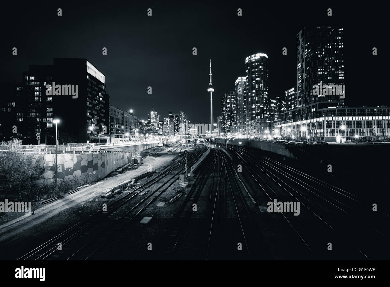 View of a rail yard and modern buildings in downtown at night, from the Bathurst Street Bridge in Toronto, Ontario. Stock Photo