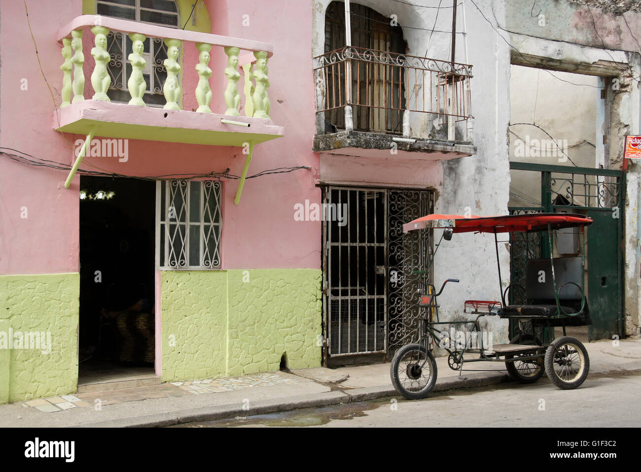 Bici-taxi outside old buildings, Havana, Cuba Stock Photo