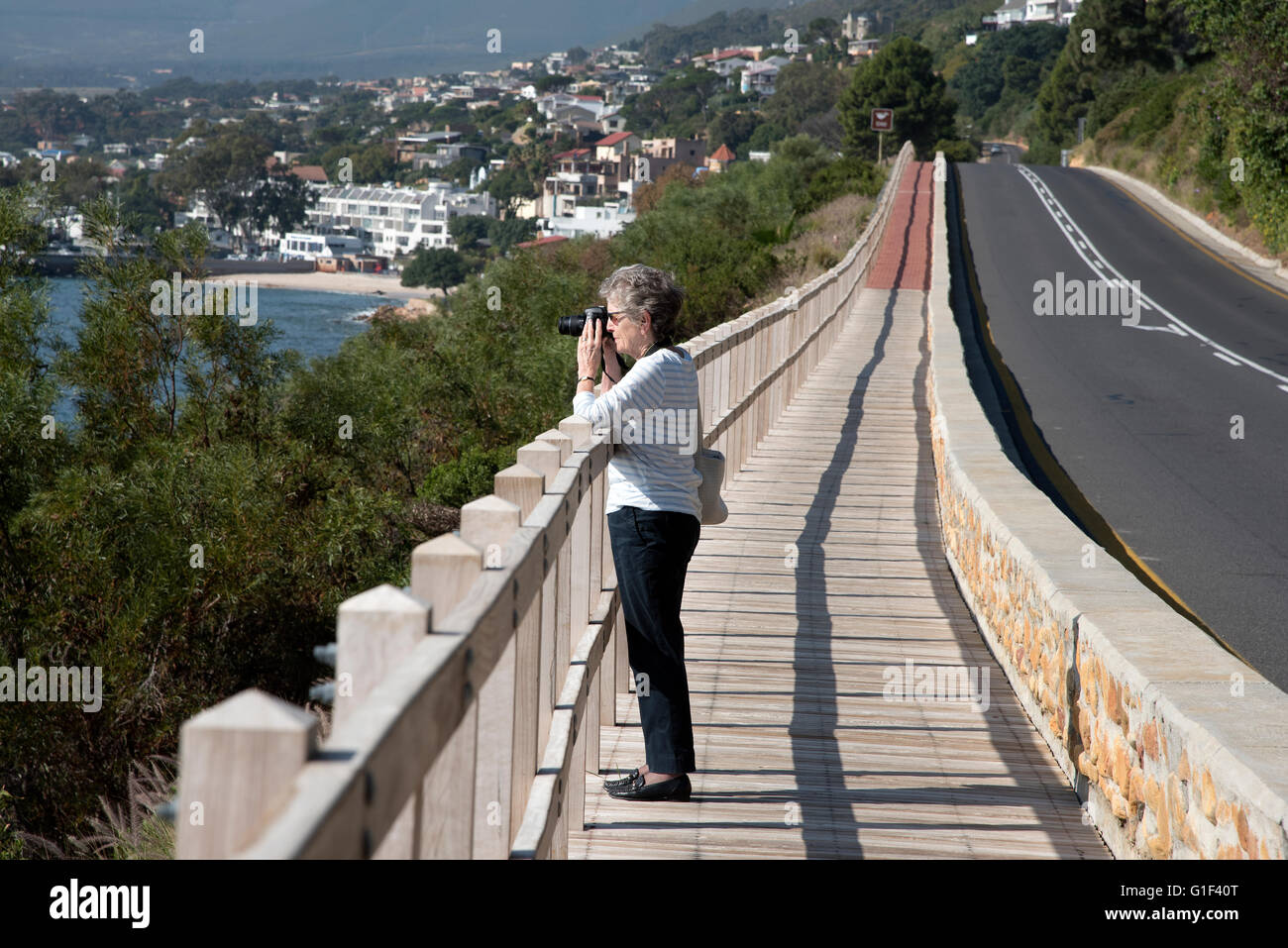 GORDON'S BAY WESTERN CAPE SOUTH AFRICA.  A pedestrian taking a photo from the walkway along the Whale watching coastal route Stock Photo