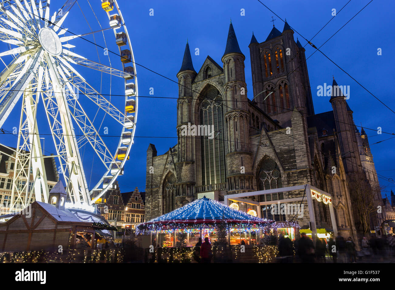 Saint Nicholas' Church in Ghent in Belgium with a ferris wheel in the foreground Stock Photo