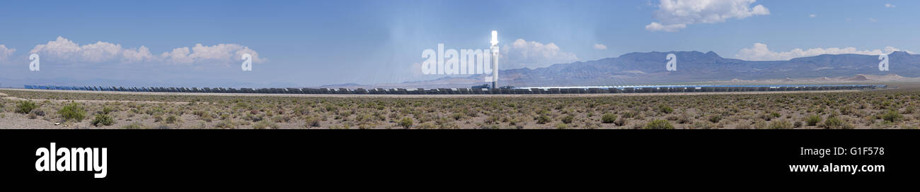 panorama of the Crescent Dunes concentrated thermal solar power plant with mirrors reflecting sunlight onto the central tower an Stock Photo