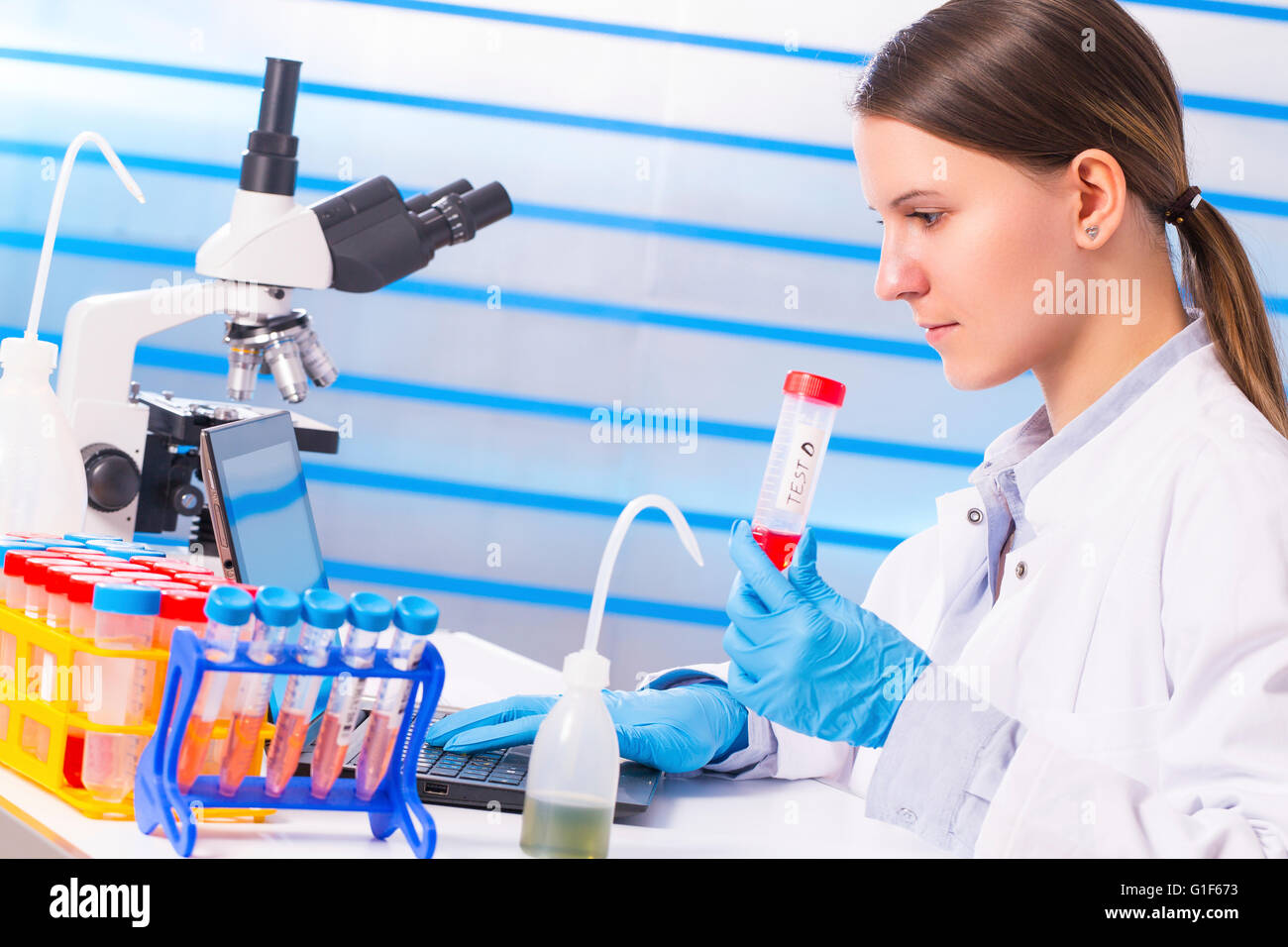 Test tube in woman hi-res stock photography and images - Alamy