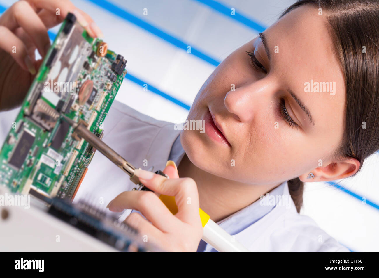 MODEL RELEASED. Female electrical engineer holding circuit board Stock