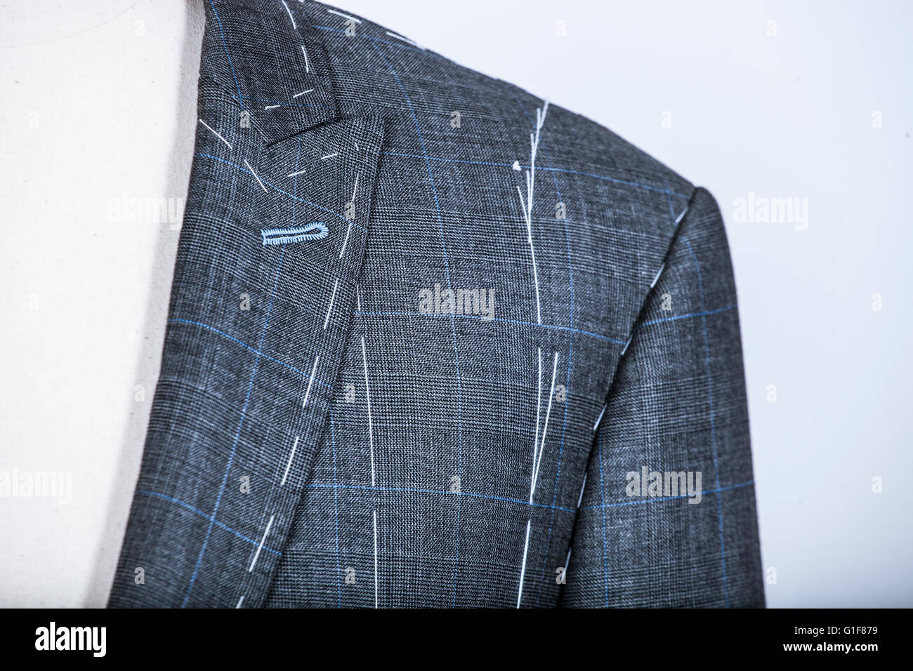 Details of a tailored suit jacket with markings on it for stitching