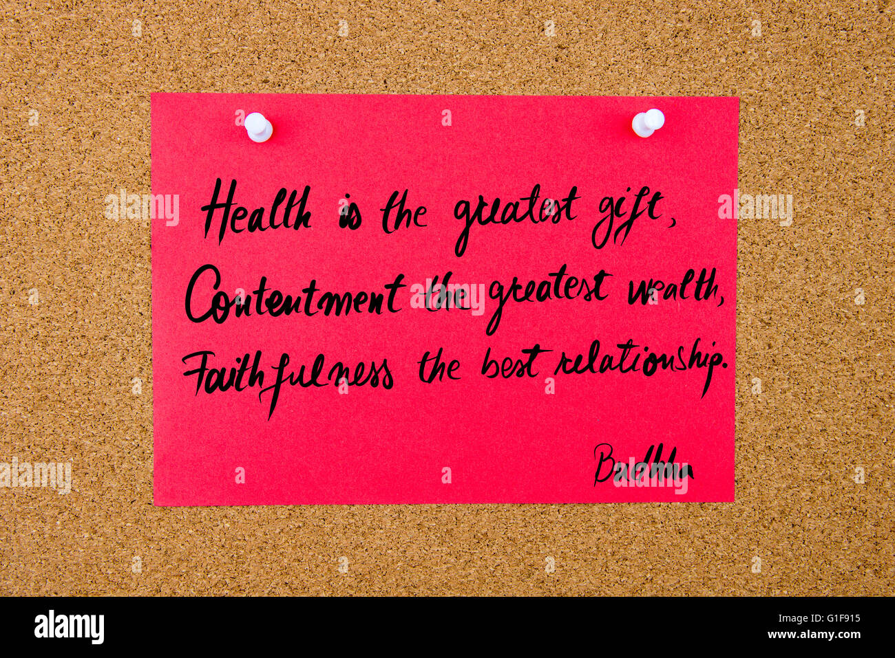 Quote Health is the greatest gift, Contentment the greatest wealth, Faithfulness the best relationship by Buddha, written on red paper note pinned on cork board with white thumbtacks, copy space available Stock Photo
