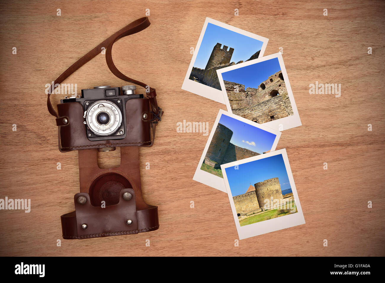 Old vintage camera in a leather case and four photos with medieval castle Stock Photo