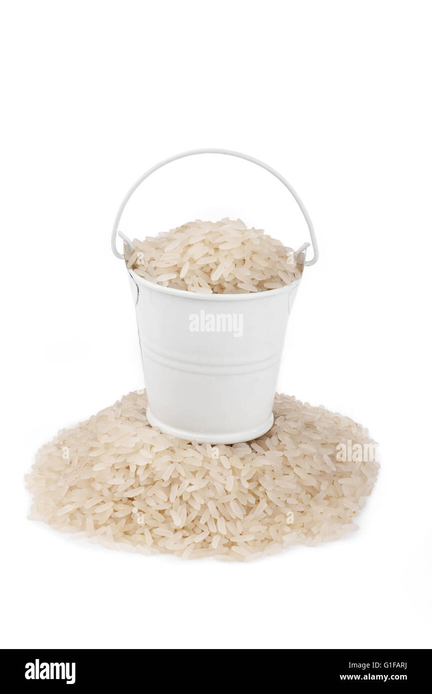 White bucket full of rice, stands on a heap rice, on a white background