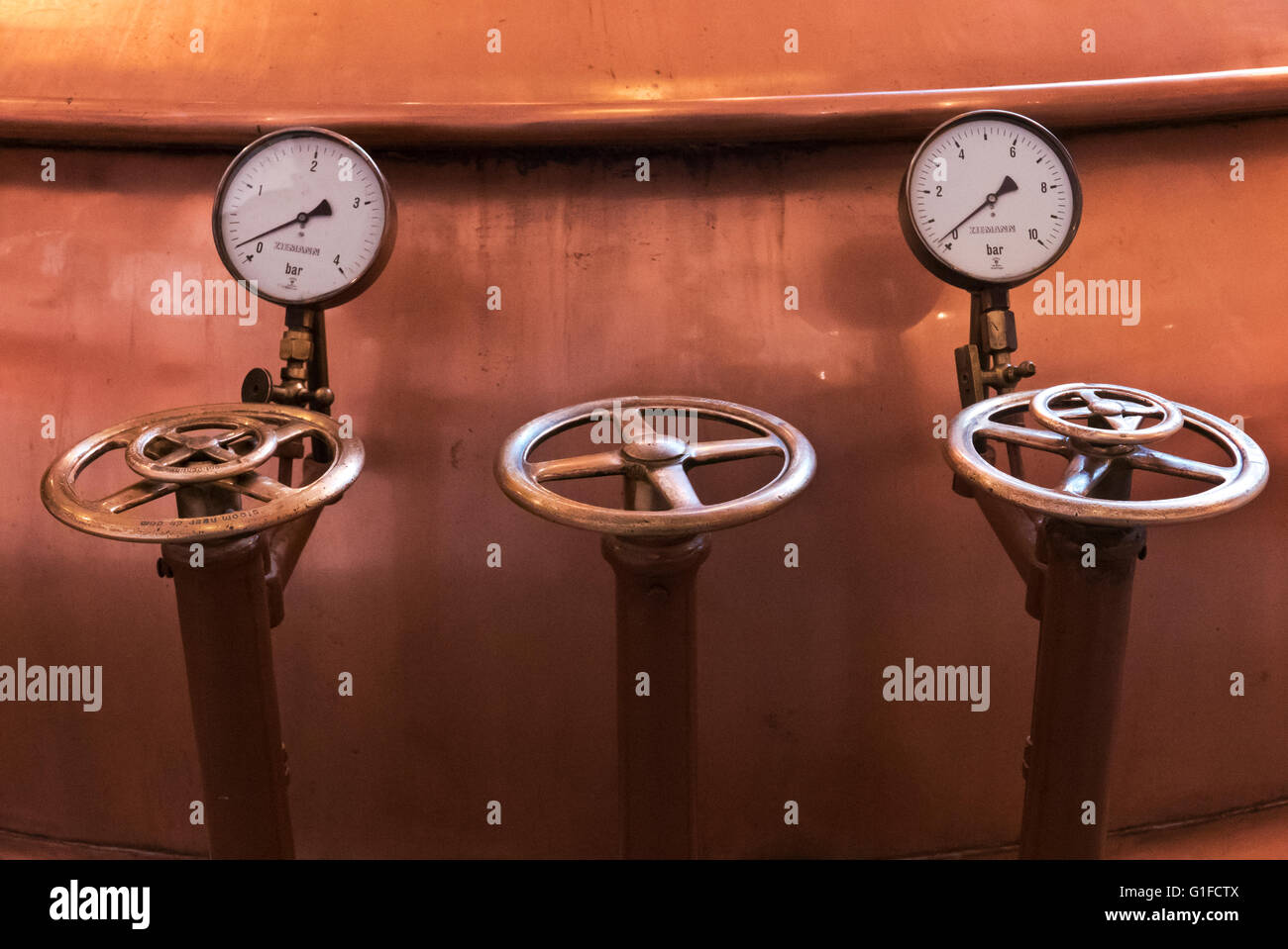 Valves by the Heineken brewing copper tanks at the Heineken Museum in Amsterdam, Holland