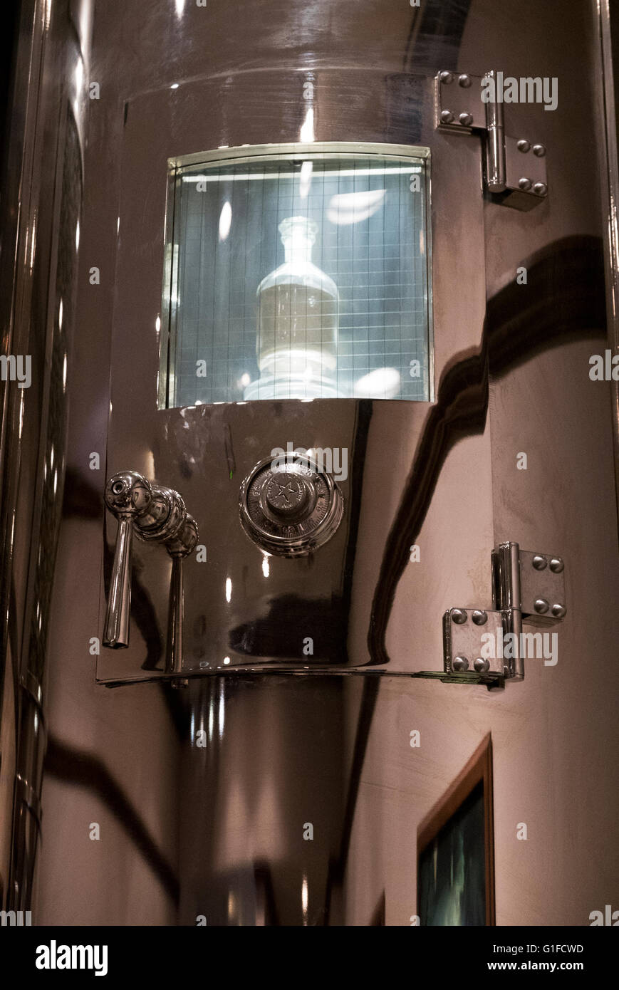 A silver cylinder with a bottle containing yeast as a model in the interior of the Heineken Museum in Amsterdam, Netherlands. Stock Photo