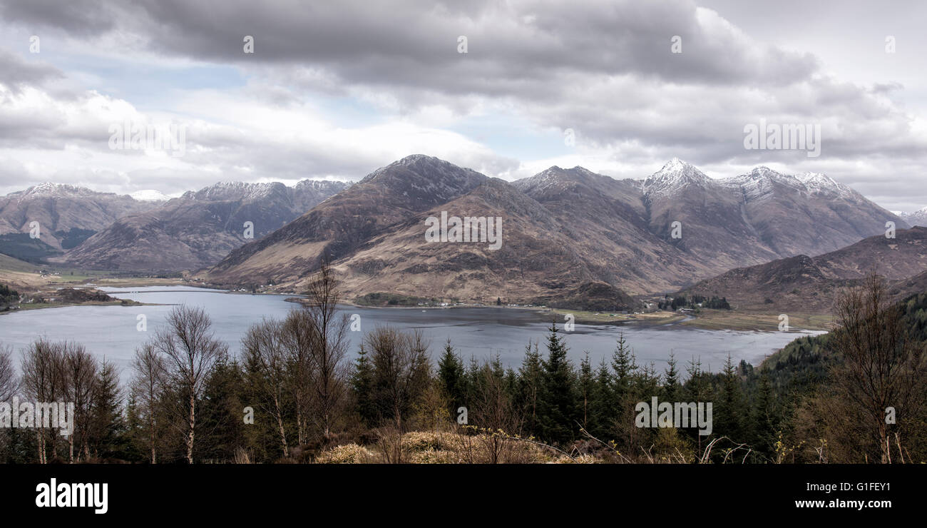 The Five Sisters of Kintail soar above Glen Shiel at the Eastern end of Loch Duich in the Western Highlands of Scotland. Stock Photo