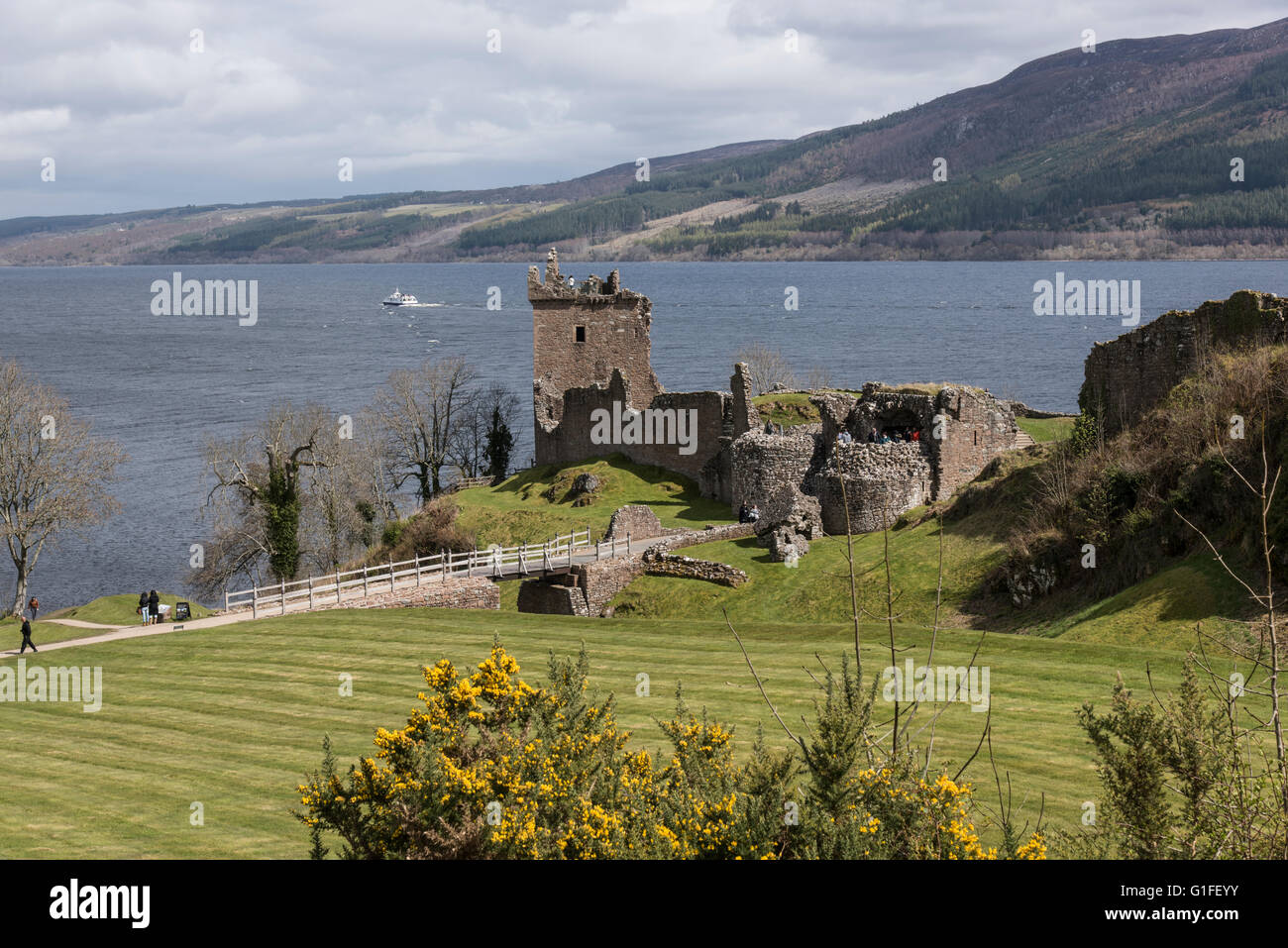 Ruined Urquart Castle sits at Stone Point overlooking the mid point of Loch Ness one of Scotlands largest lochs Stock Photo