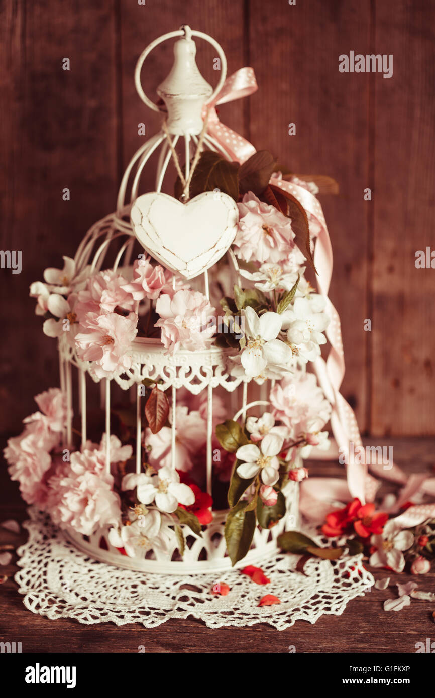 Bird cage with wooden heart Stock Photo - Alamy