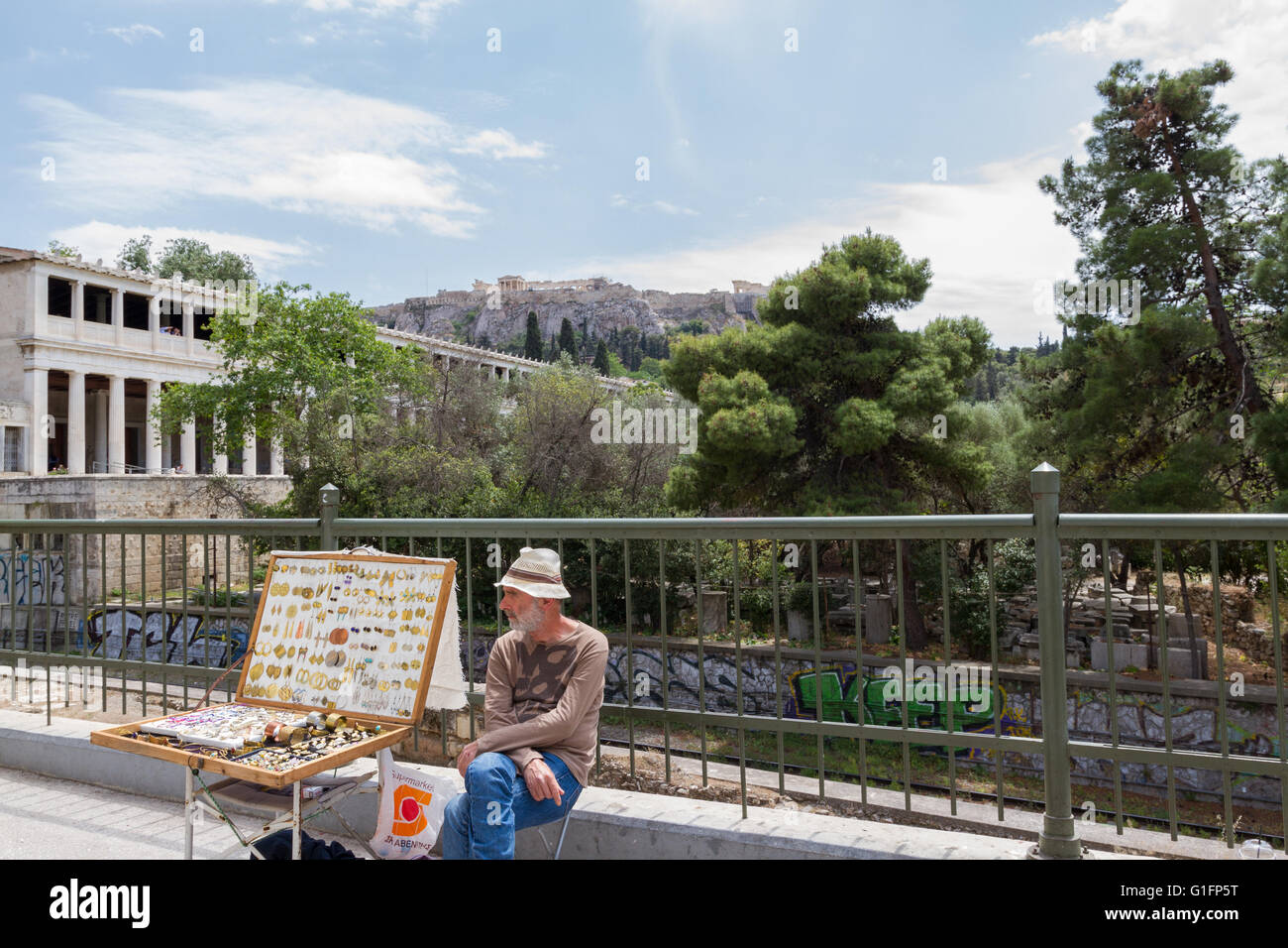 Athens, Greece - April 30, 2016: Street vendor near Stoa of Attalos of the Ancient Agora and Acropolis in the background Stock Photo