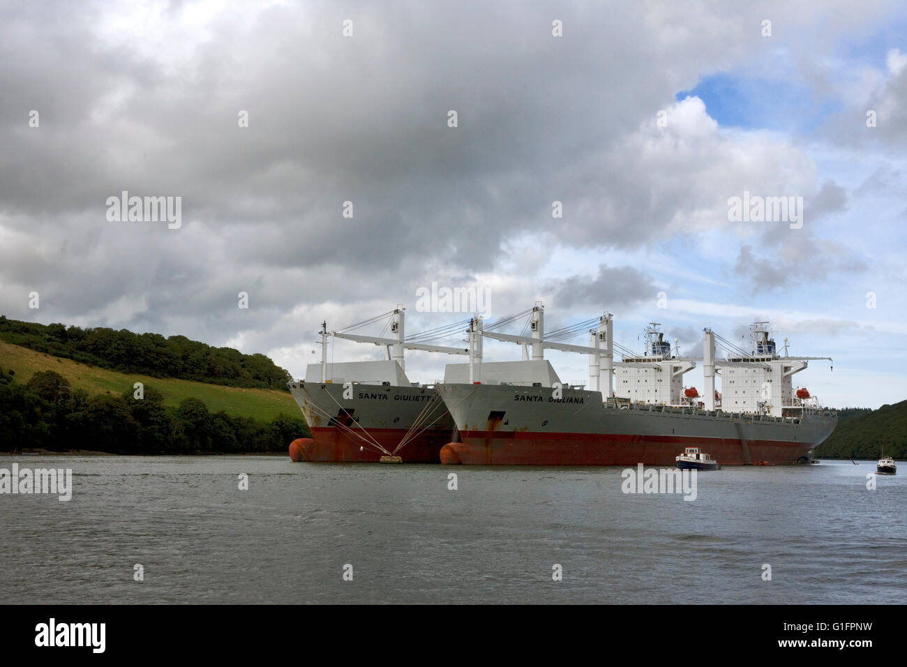 River Fal above King Harry Ferry at Tolverne, Cornwall, England, with two huge bulk freighters laid up on moorings in the river. Stock Photo