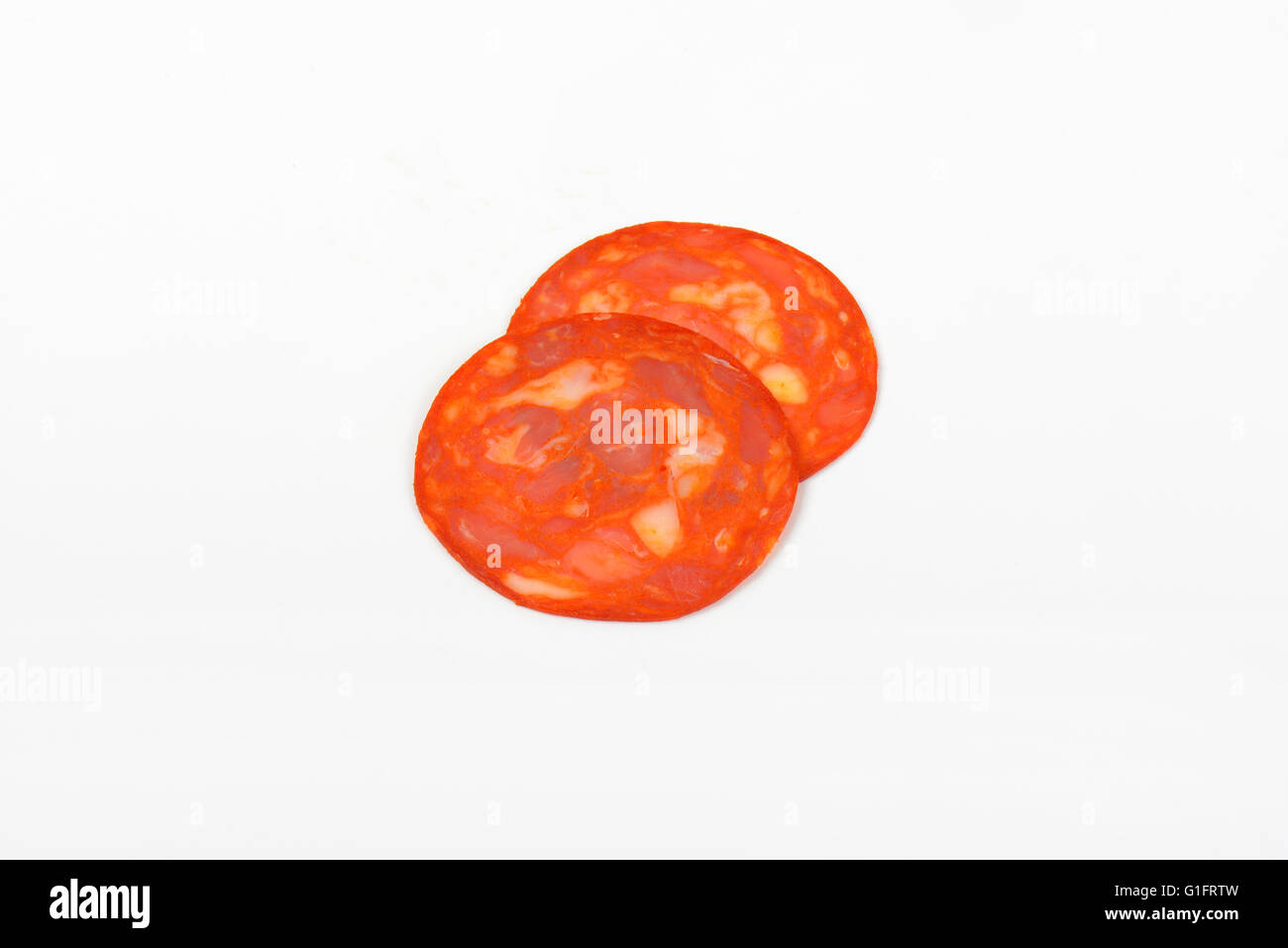 two slices of chorizo salami on white background Stock Photo Alamy
