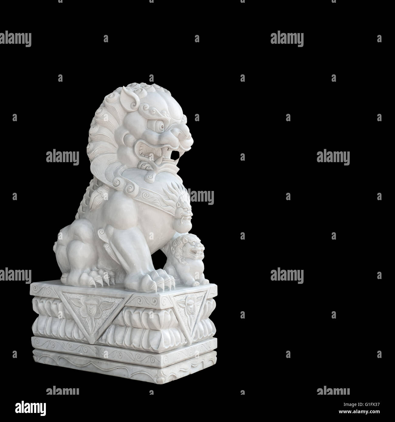 Chinese Imperial Lion statue isolated on black background. Stock Photo