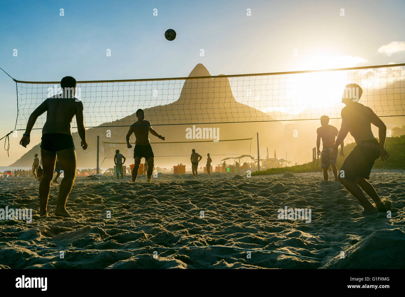 RIO DE JANEIRO - MARCH 27, 2016: Brazilians play futevôlei (footvolley, a sport combining football/soccer and volleyball). Stock Photo