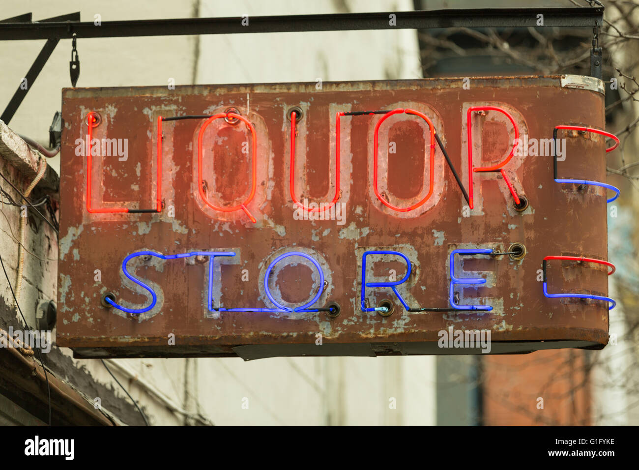 An old red and blue neon sign for a liquor store in downtown Manhattan Stock Photo