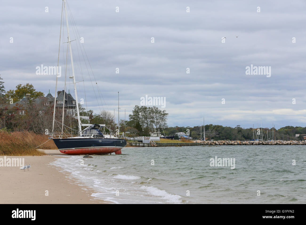 beached sailboat, washed ashore at Haven's Beach, Sag Harbor, NY Stock Photo
