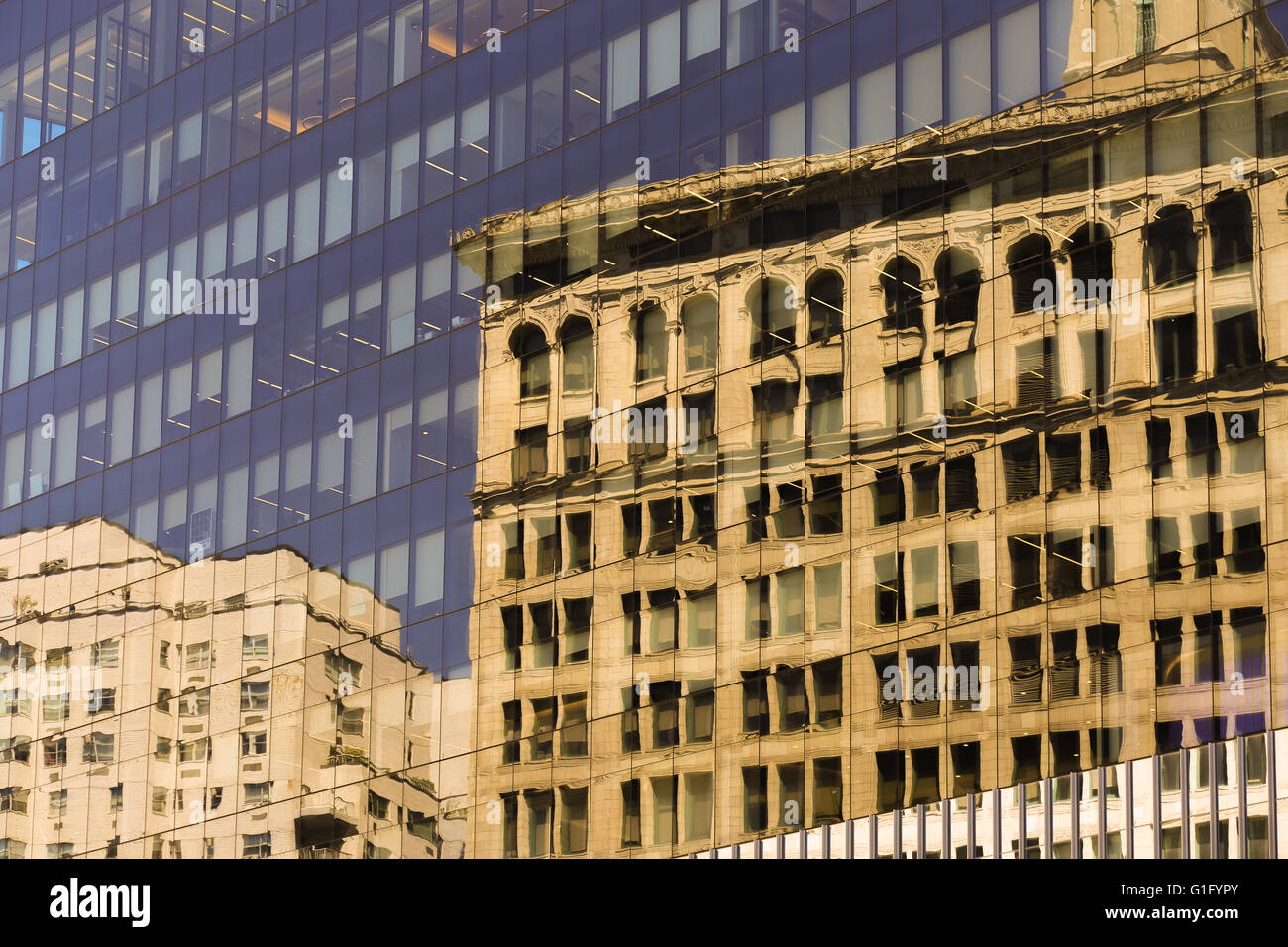 Reflection of buildings in a NYC building's glass facade Stock Photo