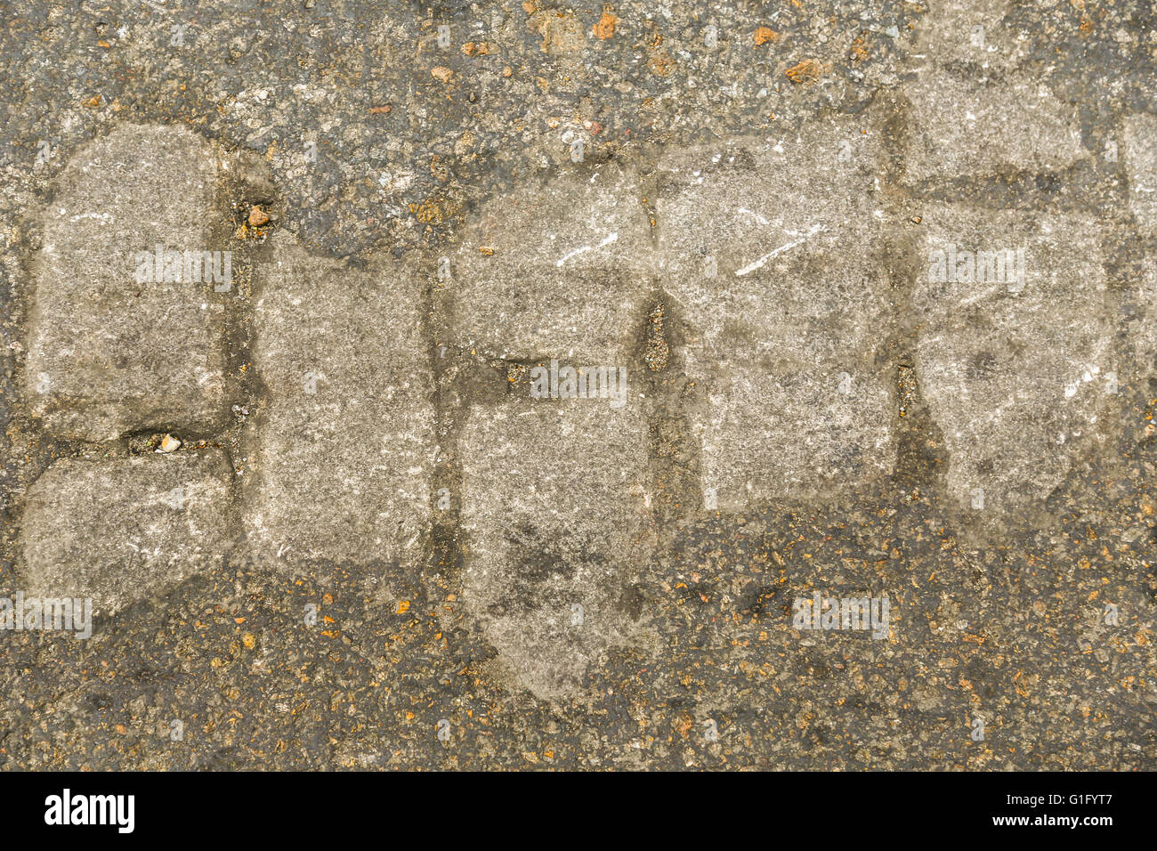 cobble stone showing through asphalt Stock Photo Alamy