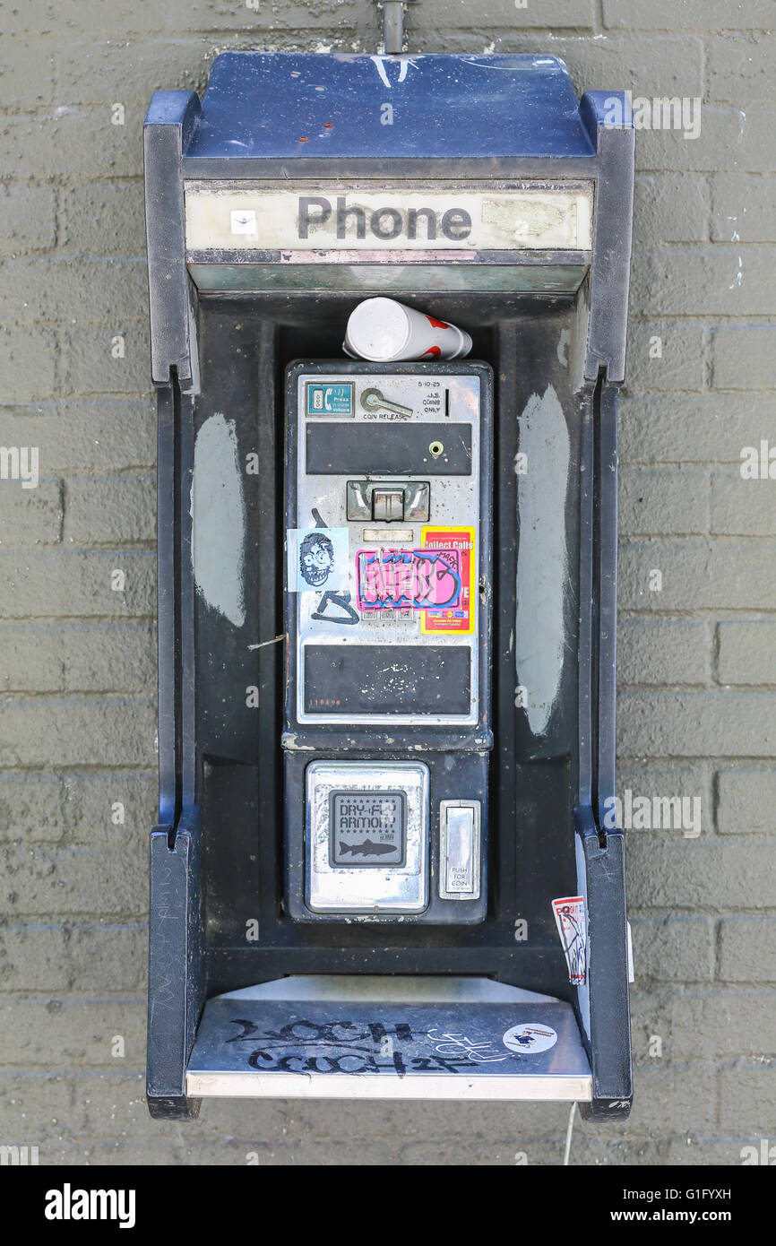 old pay phone, telephone, non working, outdoors on a wall in New Orleans Stock Photo