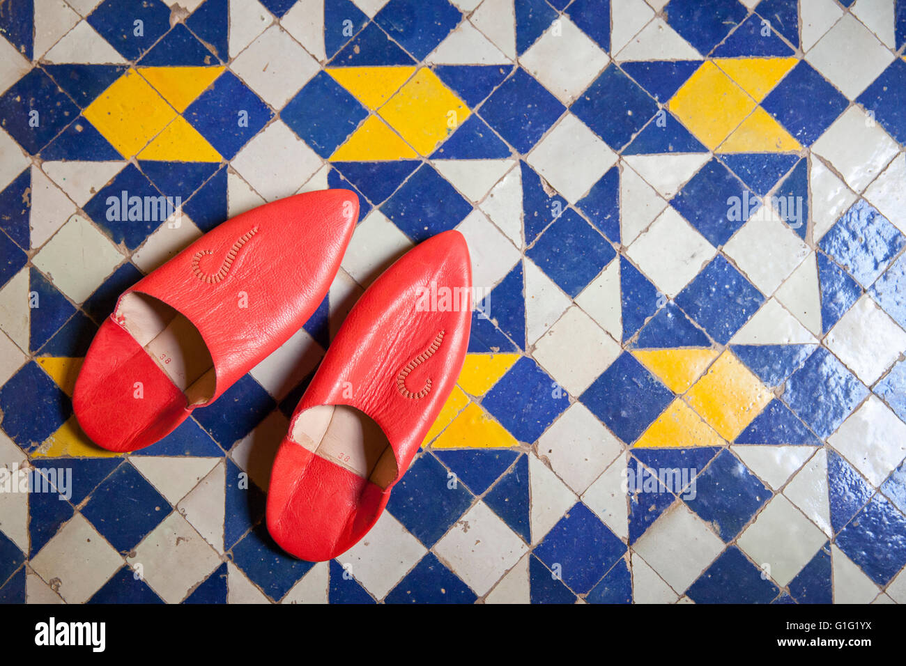 Traditional Moroccan slippers on tiled floor Stock Photo