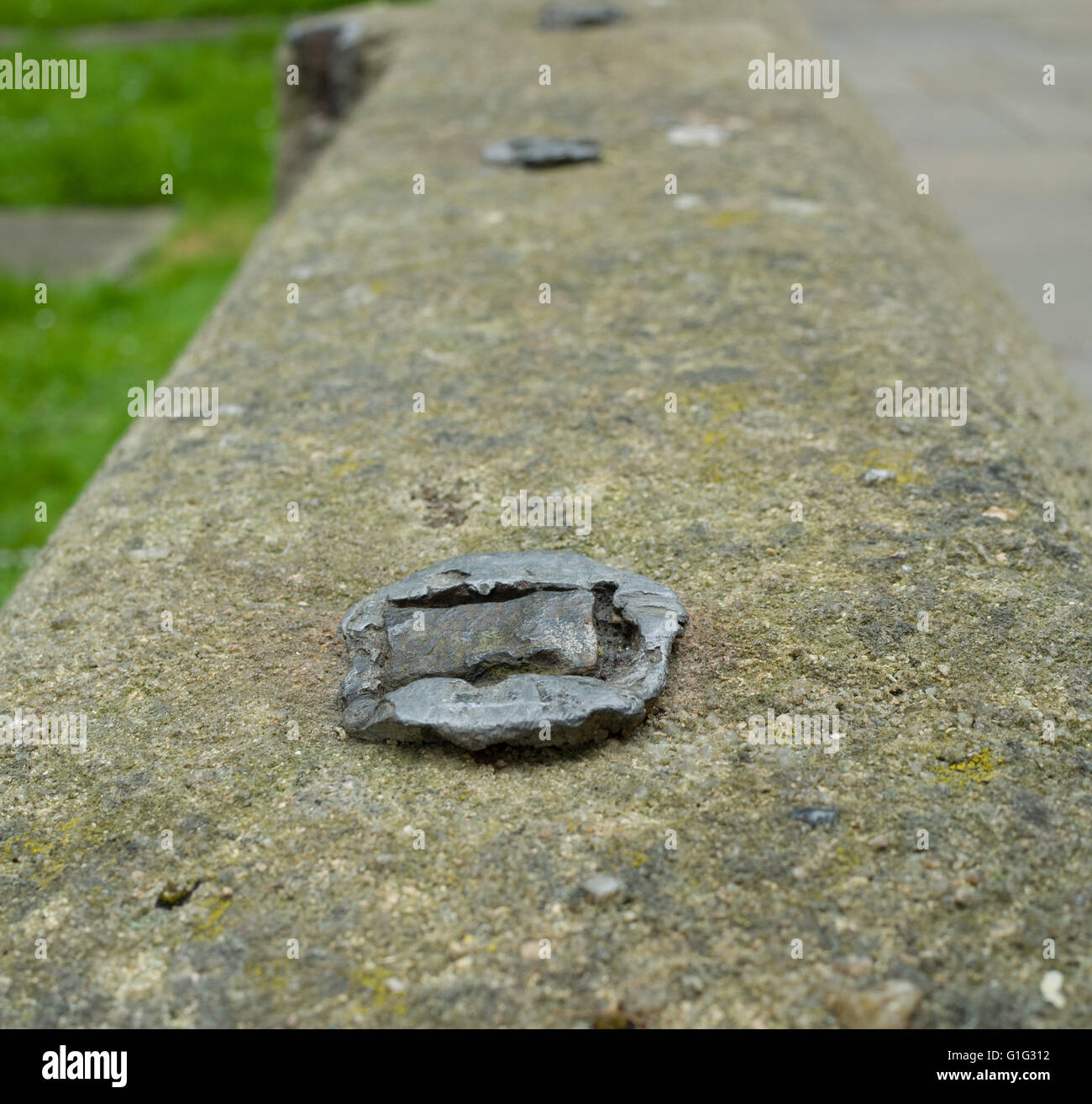 Concrete wall Iron railing removed for war effort Stock Photo