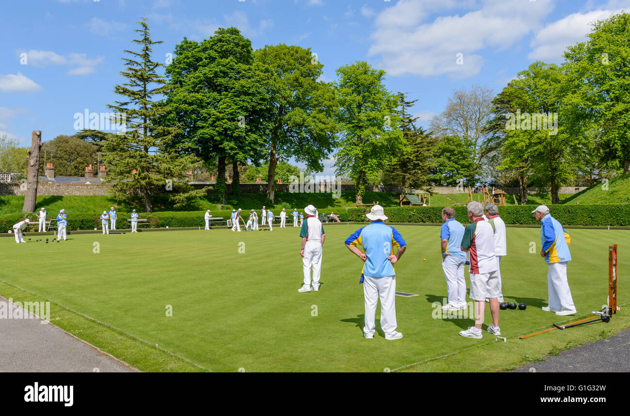 Group of elderly people bowling on a bowling green in the UK. Stock Photo