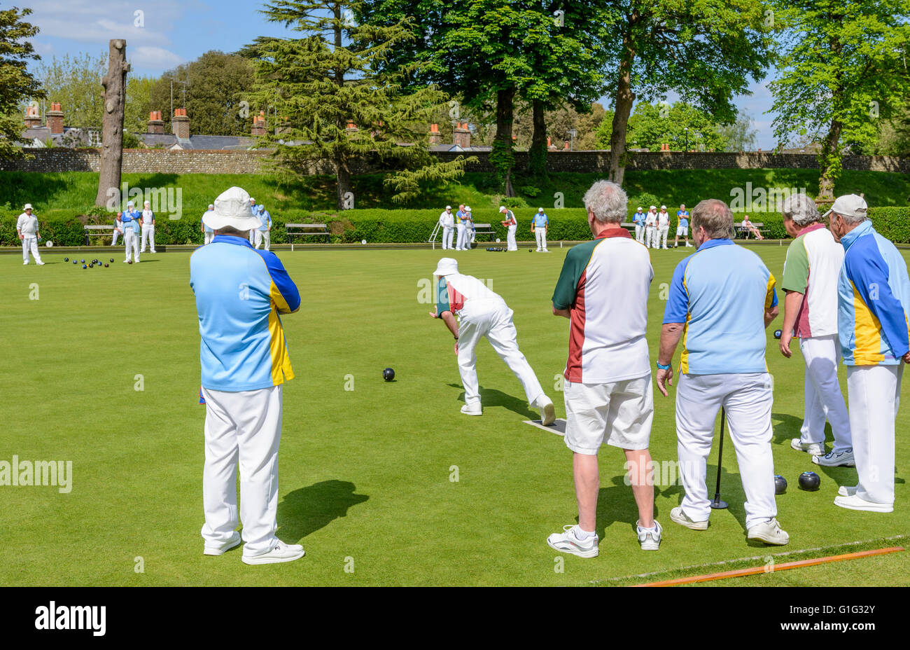 Playing bowls. Group of elderly people bowling on a bowling green in the UK. Stock Photo