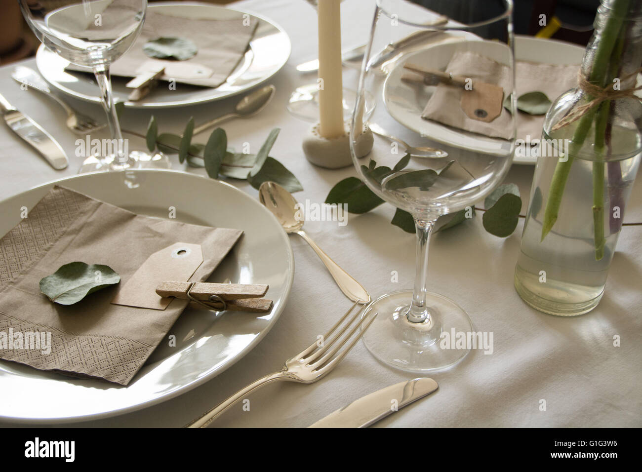 A table set for a meal, eucalyptus decoration, vintage style Stock Photo