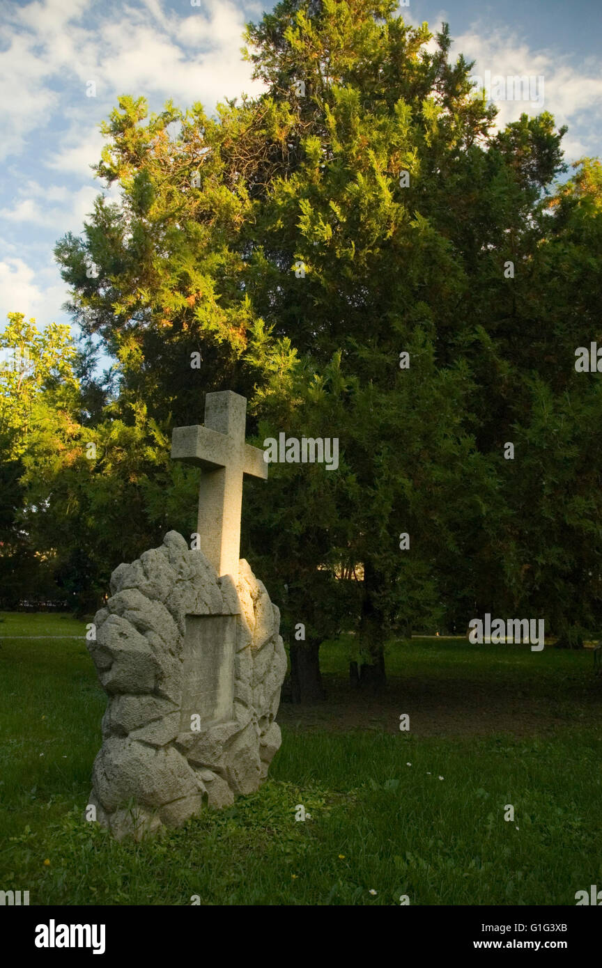 Religious cemetery with fresh green trees and grass Stock Photo