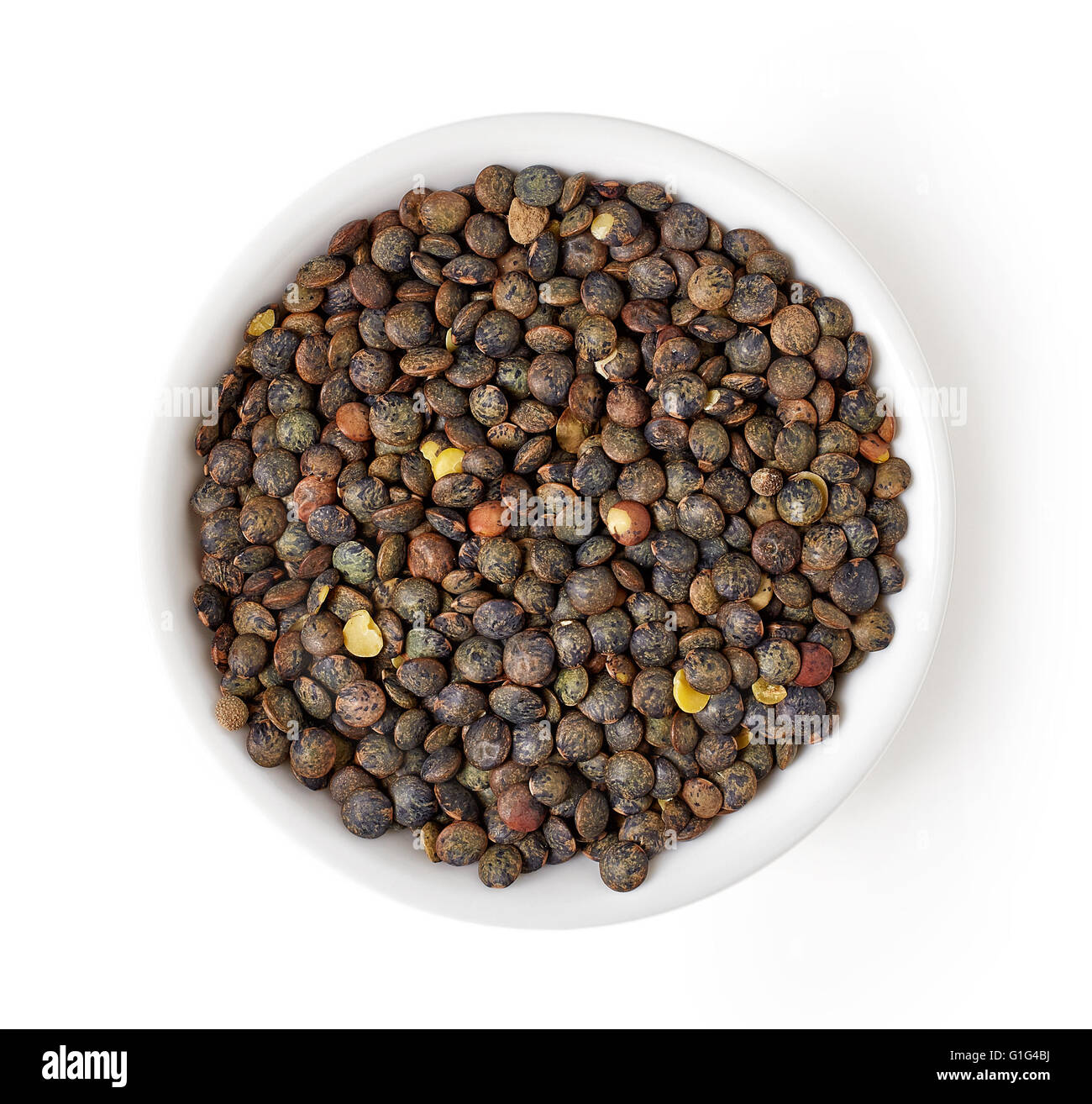 Bowl of dry green lentil isolated on white background, top view Stock Photo