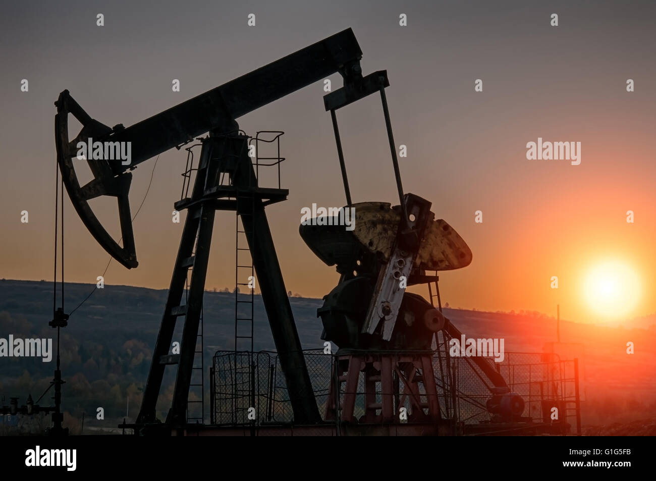 Oil Pump on orange sunset Stock Photo