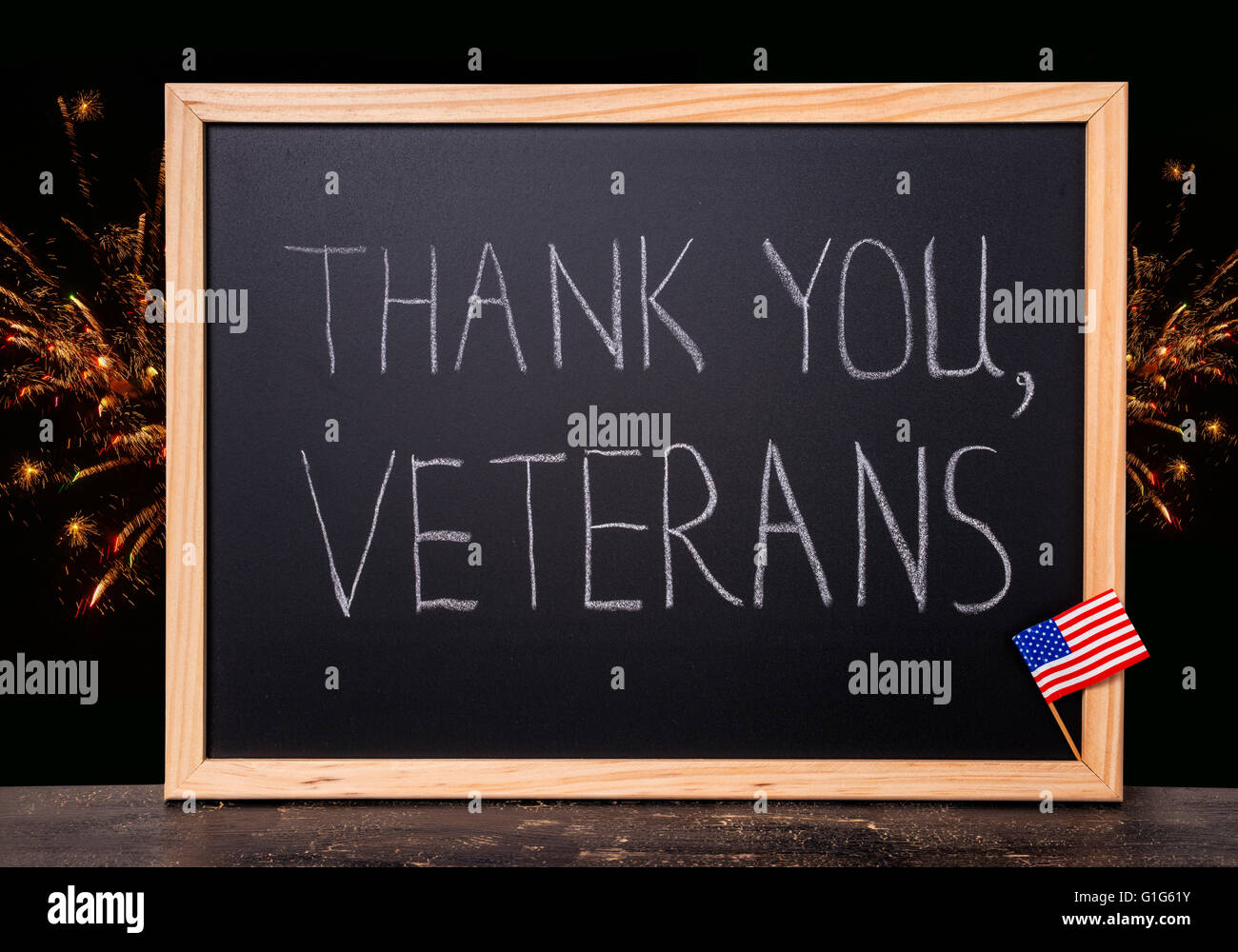 greeting card of handwriting text thank you veterans is written in chalkboard with flag United States and firework on craquelure Stock Photo
