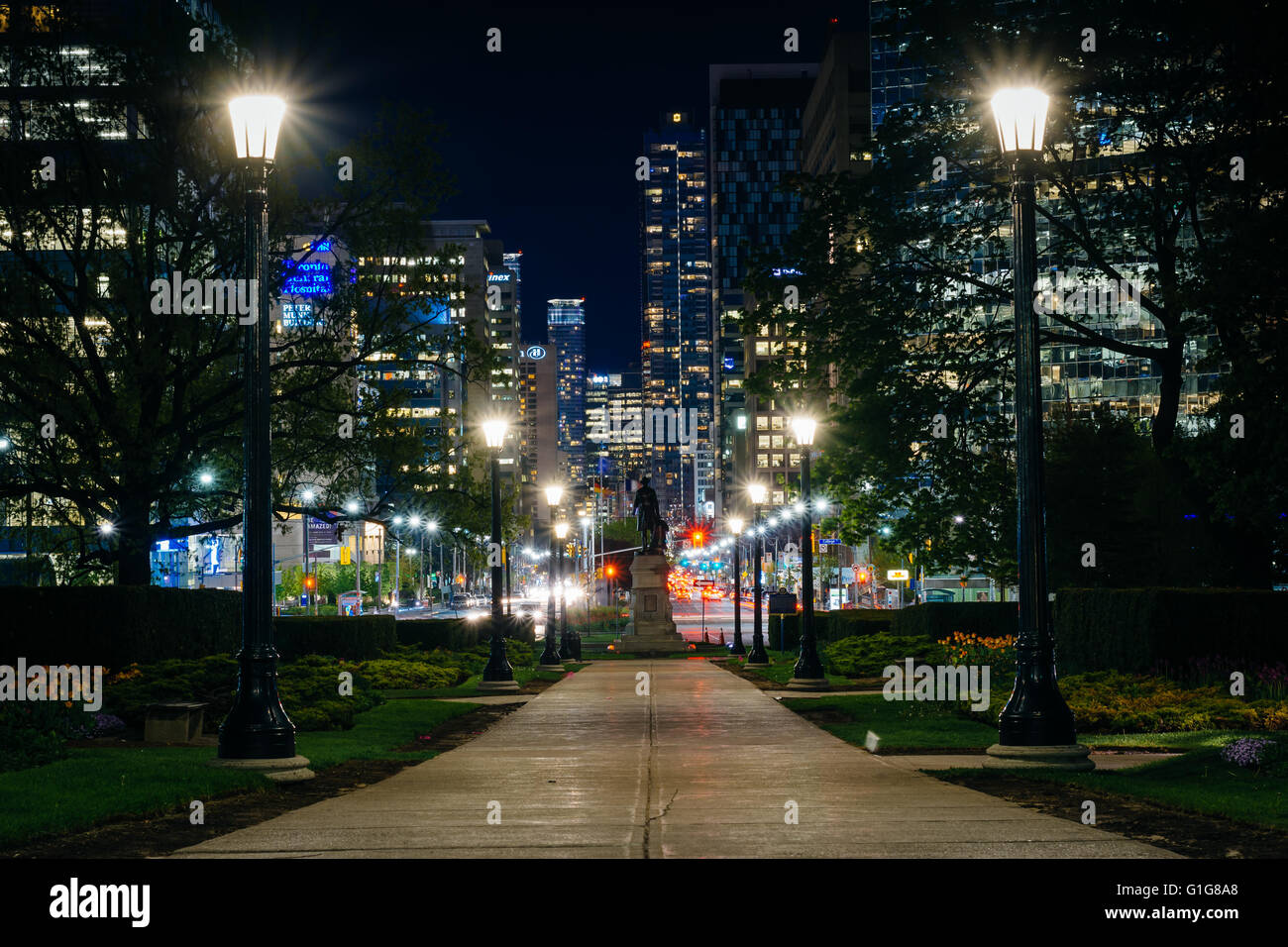 Statue and walkway at Queen's Park, and buildings on University Avenue at night, in Toronto, Ontario. Stock Photo