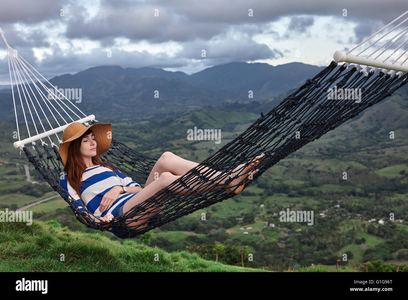 Young woman lying in a hammock Stock Photo - Alamy