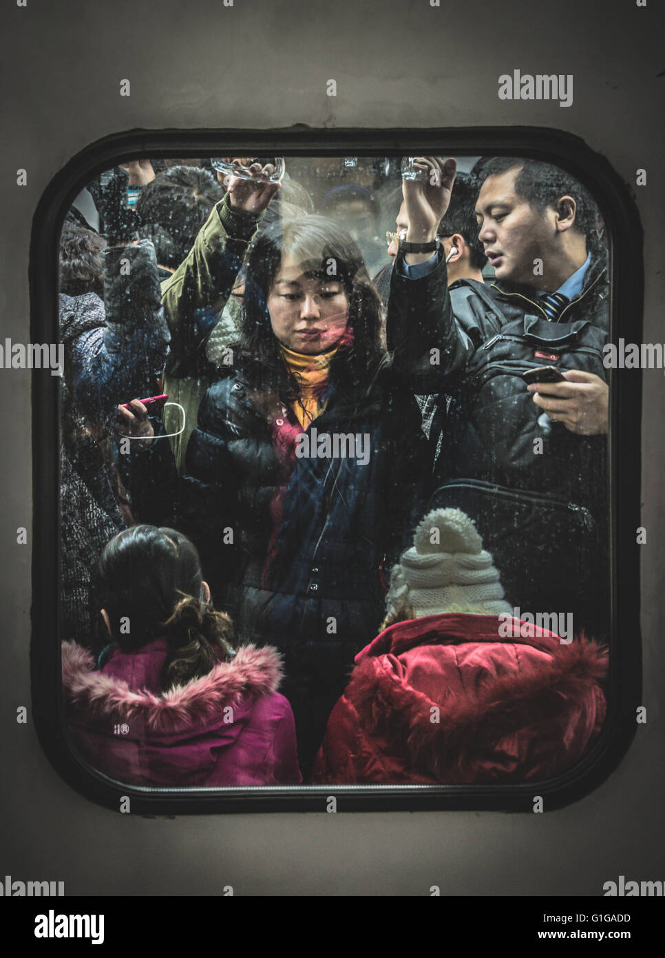Cramped commuters on the Beijing Metro during rush hour Stock Photo