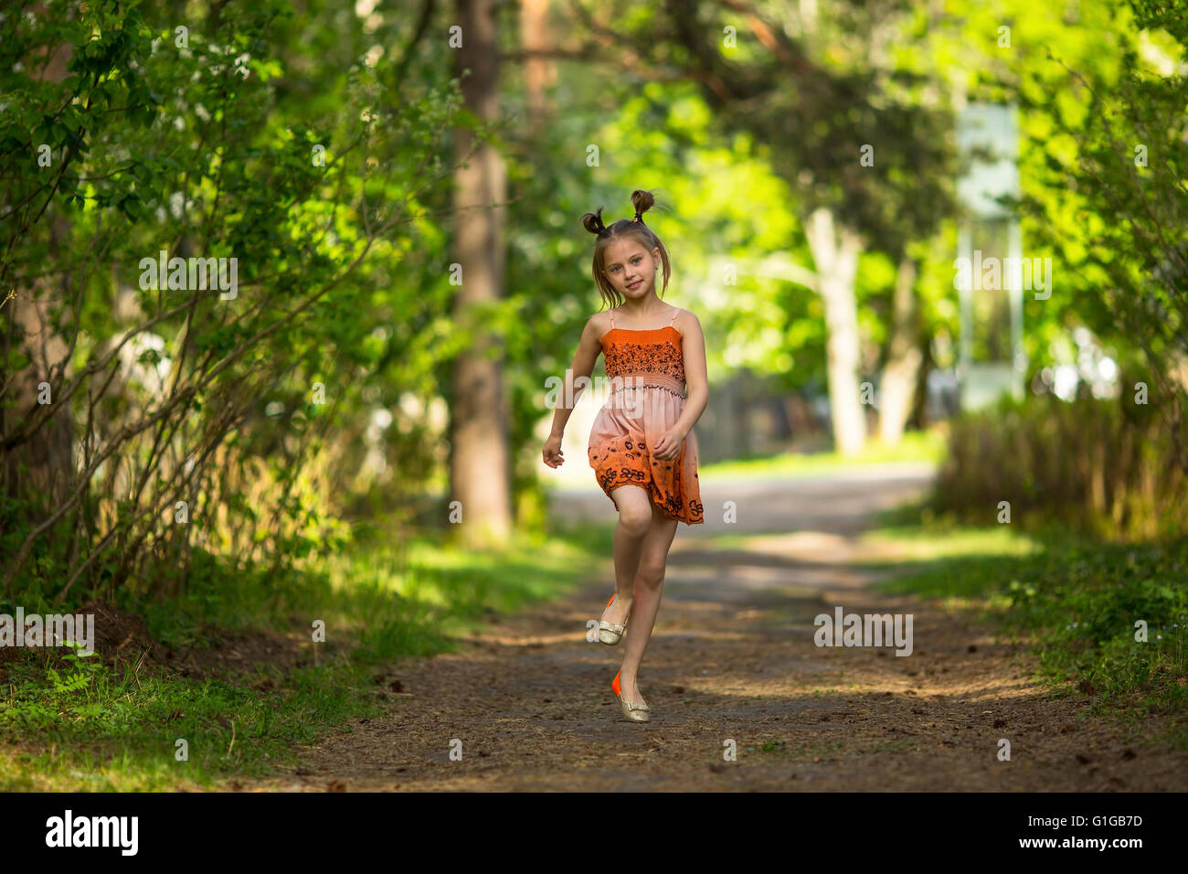 Cute little girl running jogging on the park on summertime 9639923
