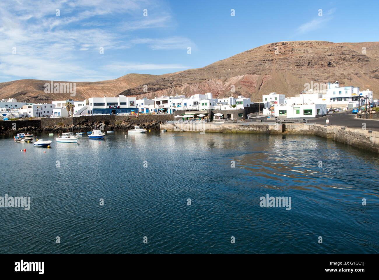 Harbour and white houses in the fishing village of Orzola, Lanzarote ...