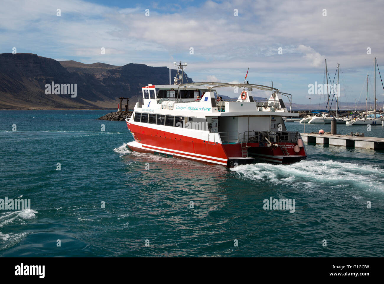 Tourist ferry boat Biosfera Express leaving the harbour Caleta de Sebo