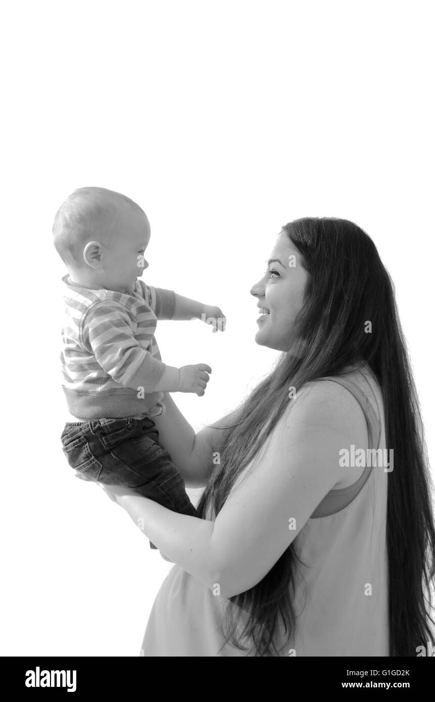 Mother hold her son on hands smiling isolated on white Stock Photo