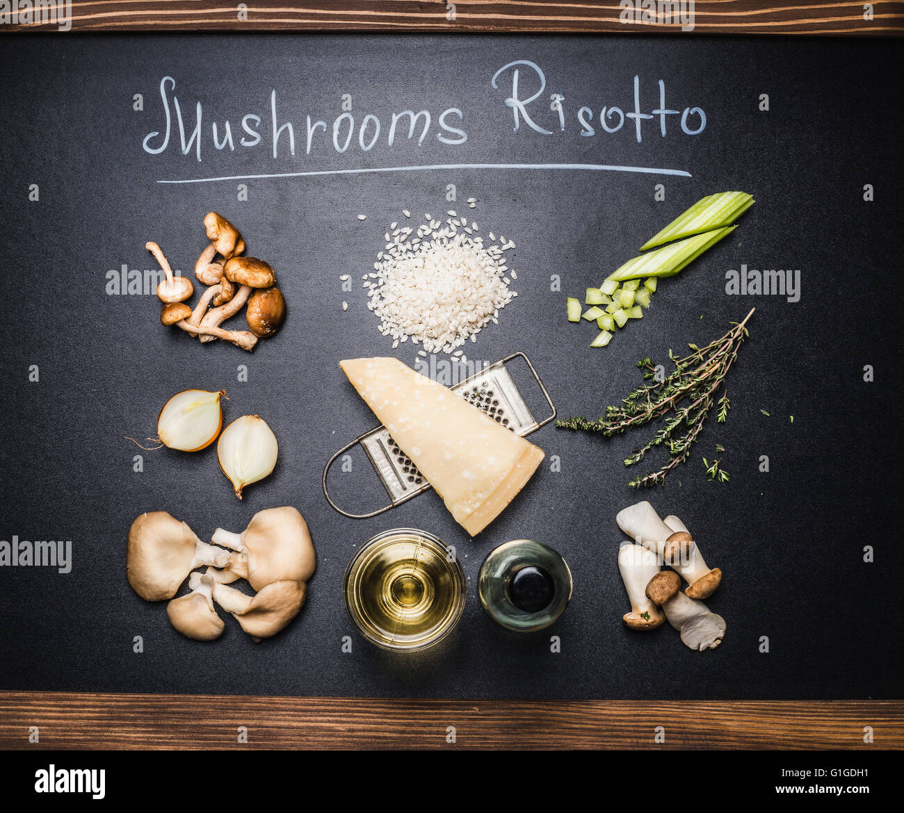 Mushrooms risotto ingredients setting on chalkboard background with text, top view.  Italian food concept Stock Photo