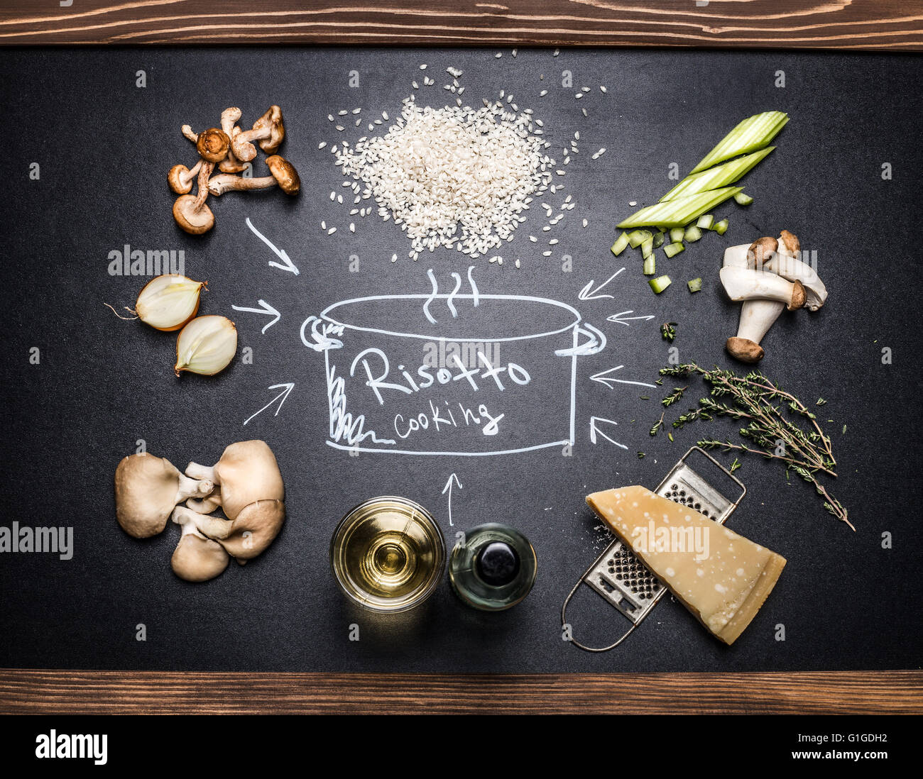 Cooking Ingredients for mushrooms risotto with  hand drawings on dark chalkboard. Italian food Stock Photo
