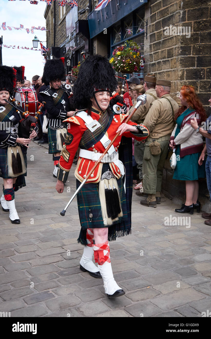 Durham pipe band marching down Haworth high street surrounded by crowds ...